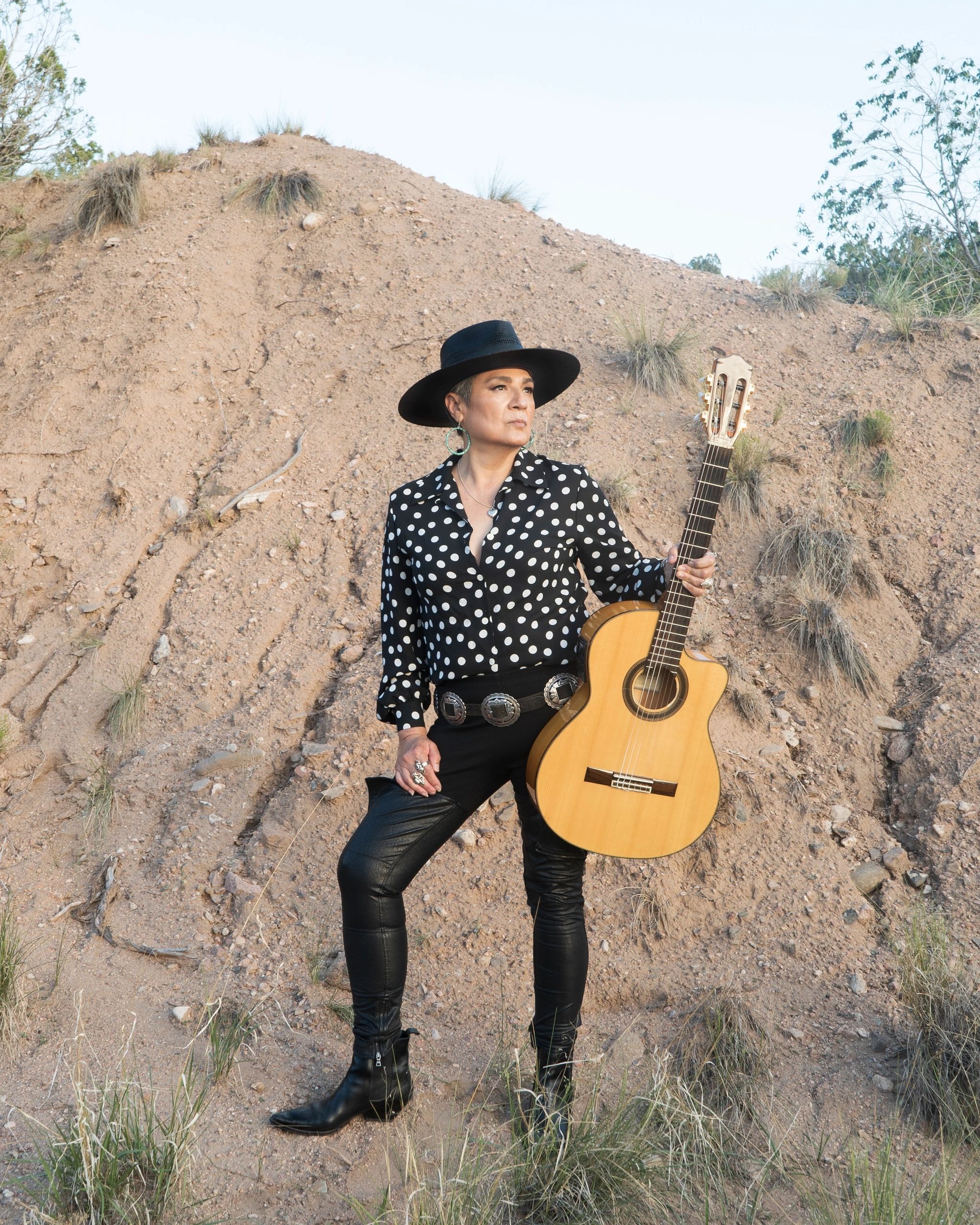 Nacha Mendez performing with guitar